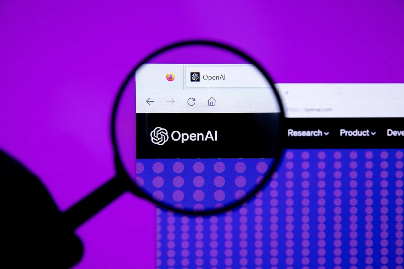 The OpenAI logo under a magnifying glass. Sam Altman’s company is rebuilding a robotics team years after shutting down the last one.