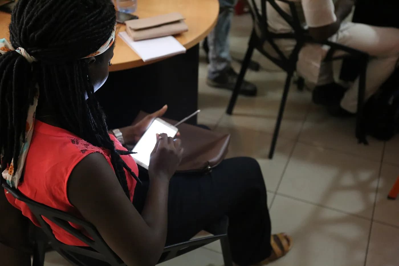 A participant at a Wikimedia workshop in Lagos checks her smartphone, May 2017. Mobile remains the main way Nigerians get online.